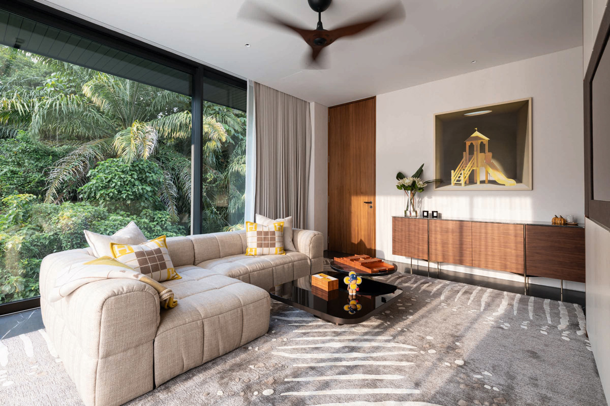 This cosy space features by Architology Interiors cheerful yellow accents and a backdrop of lush foliage