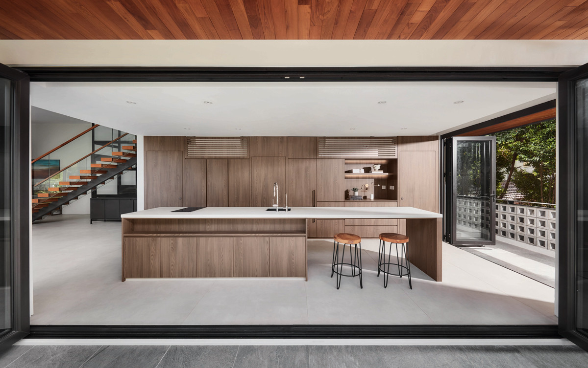 The terrace house’s clean-lined kitchen opens generously to the outdoors