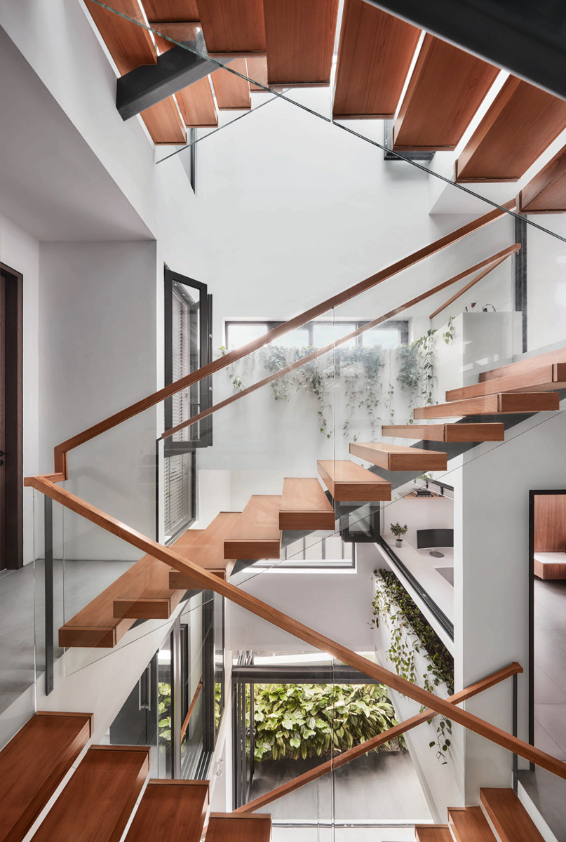 A light well beside the terrace house’s staircase invites sunlight and breezes in