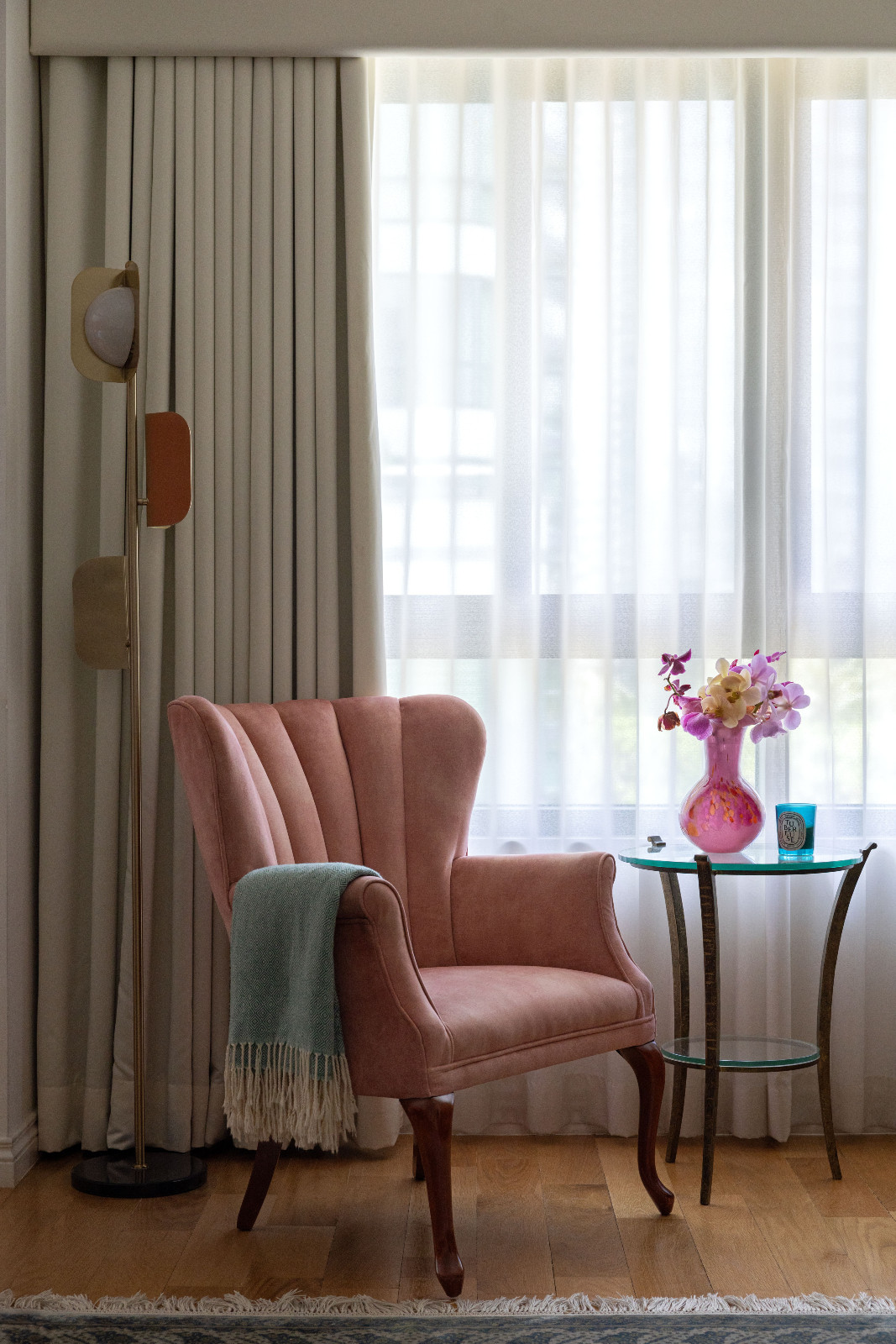 A reading nook spot clad in Stephanie Zubiri's home clad in soft pink hues and gentle fabrics