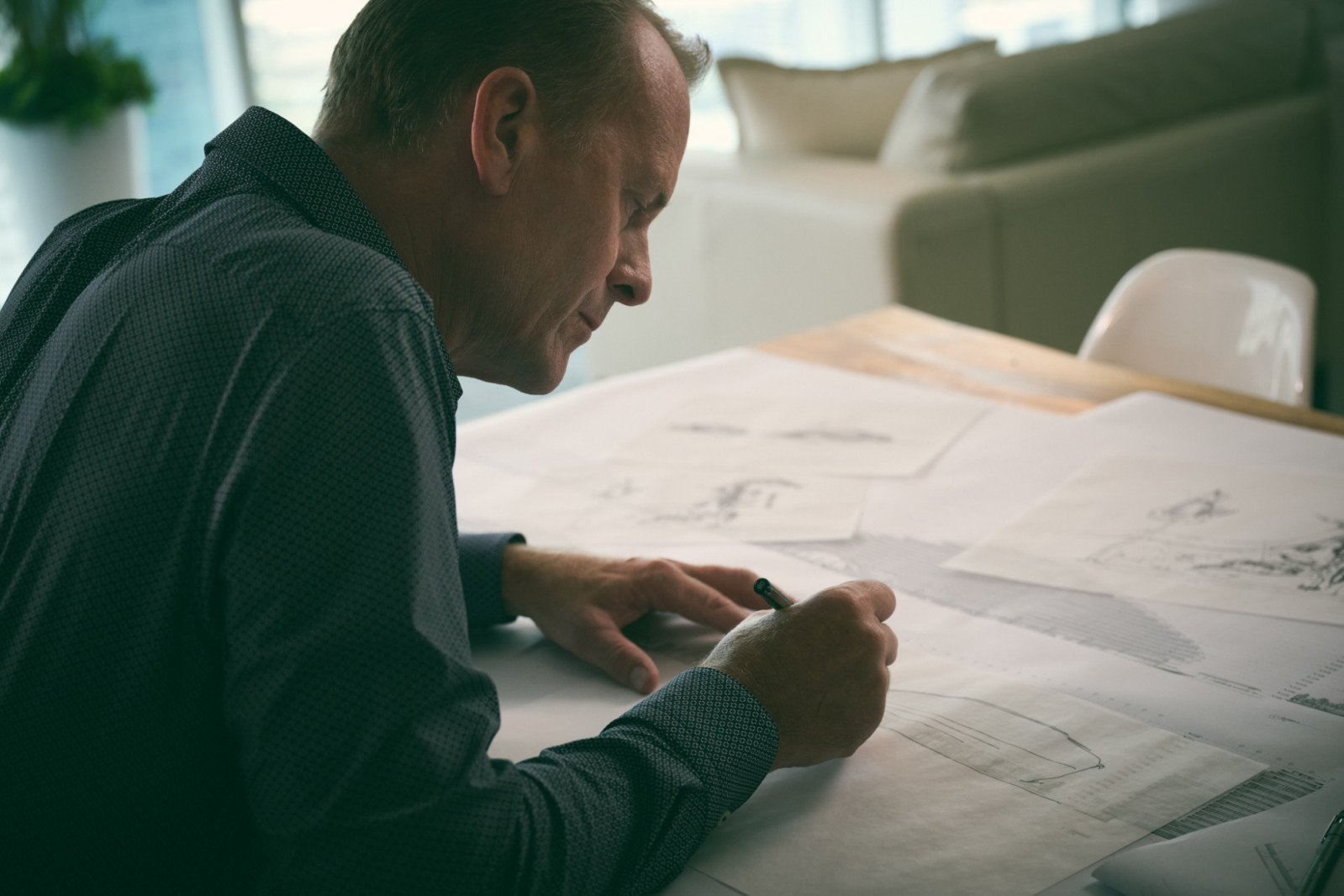 Shaun Killa reviews architectural plans in his Dubai studio, where hand-drawn sketches evolve into some of the world’s most recognisable buildings