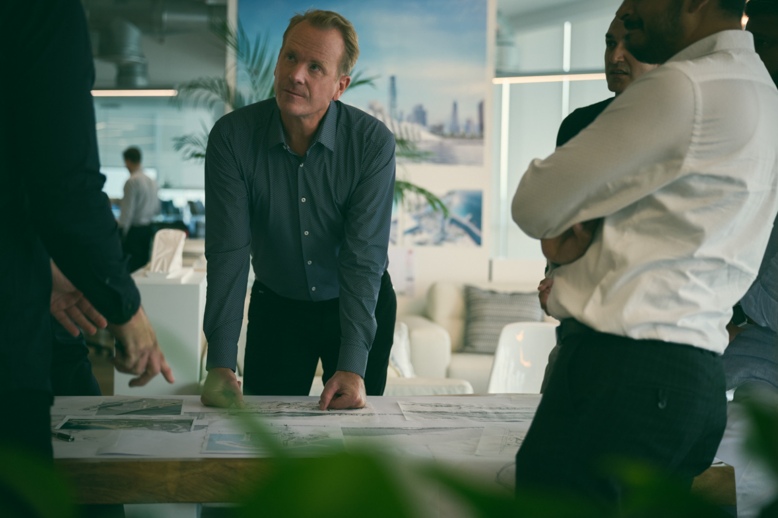 In his Dubai studio, Shaun Killa reviews architectural plans with his team, surrounded by the models and drawings that transform ambitious concepts into buildable realities