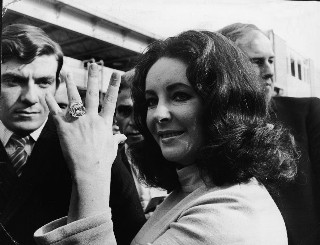 British-born actress Elizabeth Taylor shows off the 33.19 carat diamond ring given to her by husband Richard Burton. (Photo by Express Newspapers/Hulton Archive/Getty Images)
