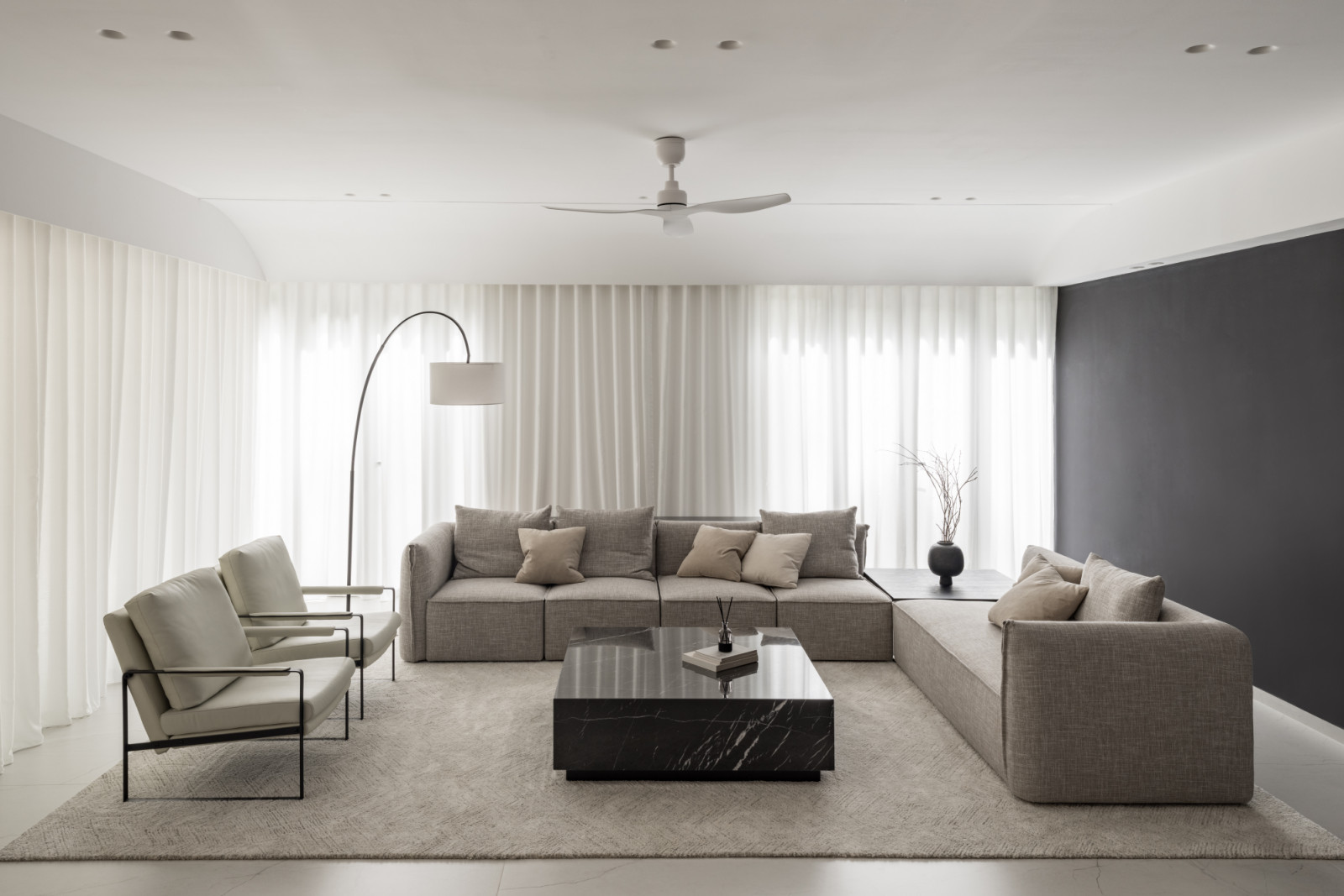 The open-plan ground floor with neutral tones of white, grey, and black create a cohesive whole