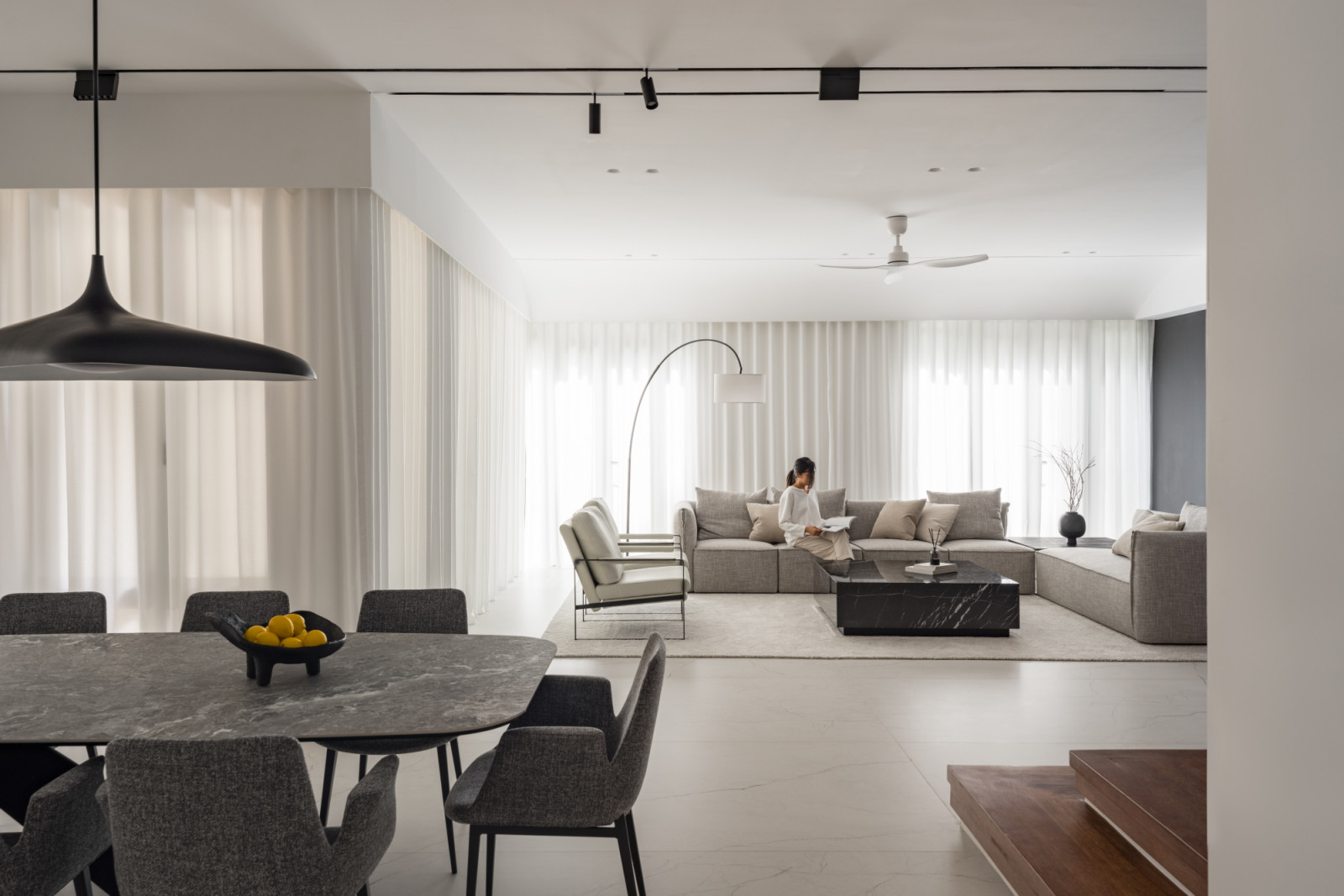 Black pendant lighting defines the dining space, whilst the open layout allows views through to the living area