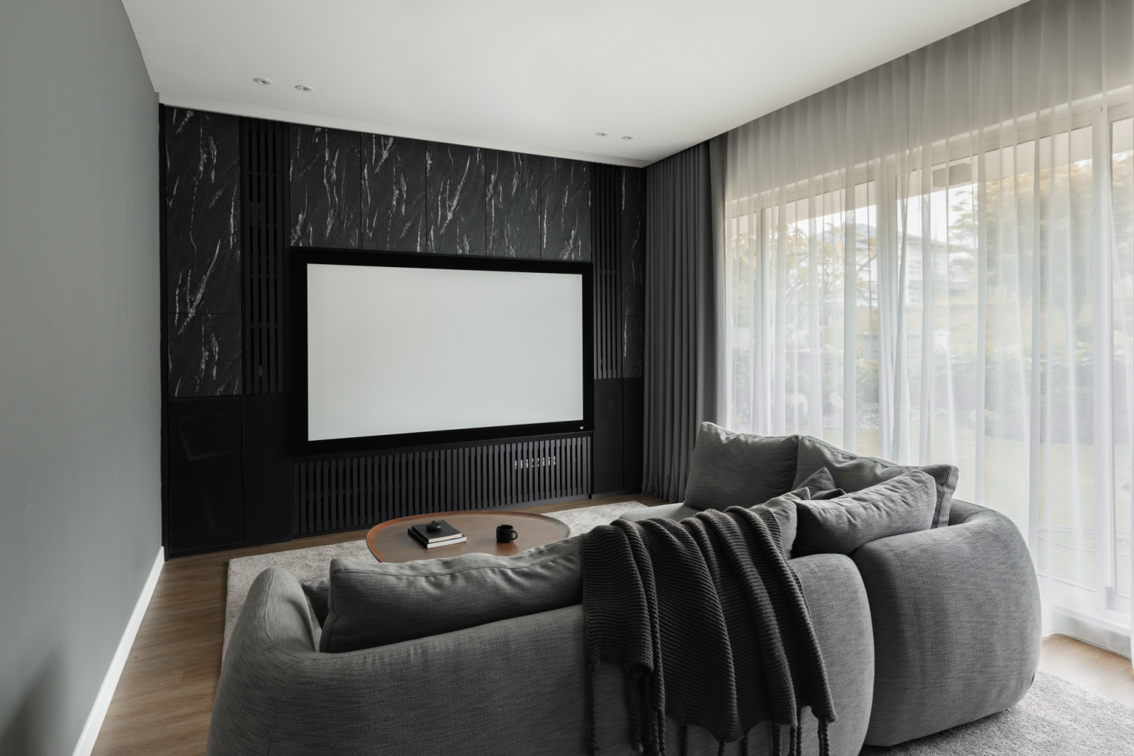 The upstairs family room features the elegant wood flooring and a built-in media unit that extends into bench seating