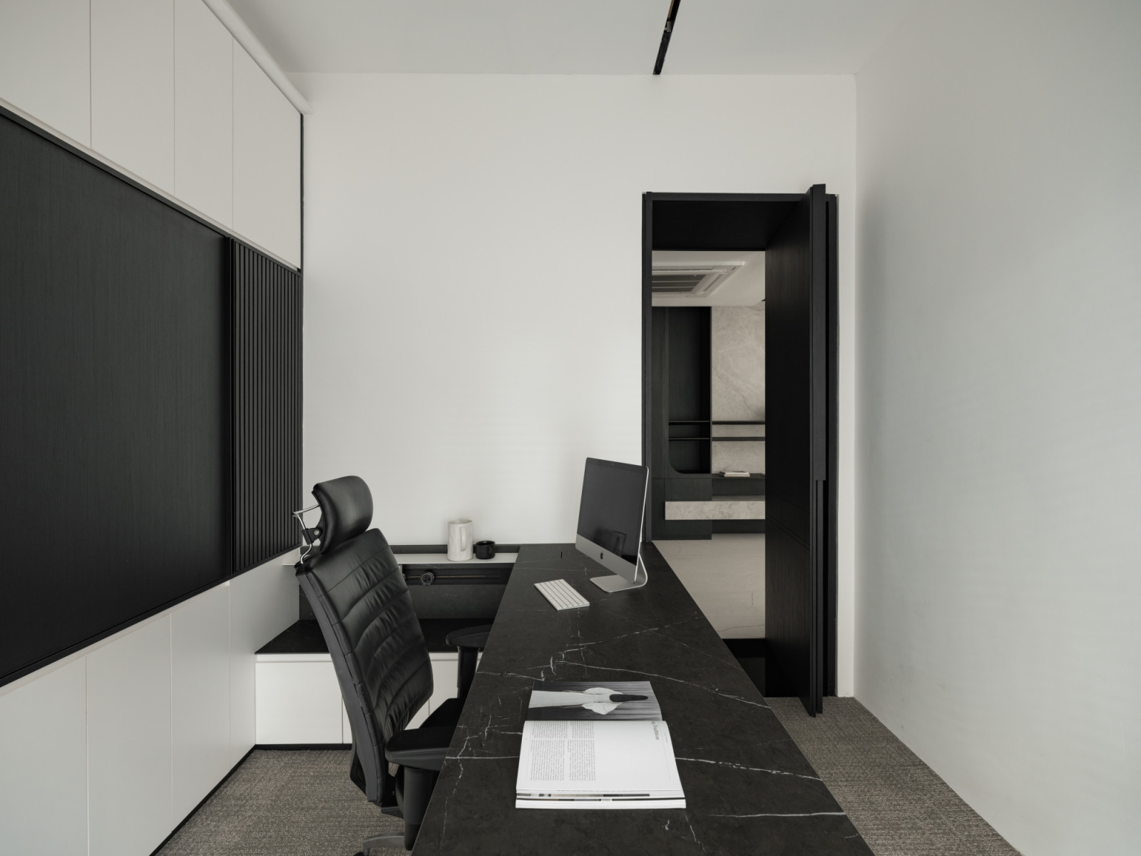 The home office features built-in storage and a black marble desk surface, exemplifying the custom cabinetry and personalised décor