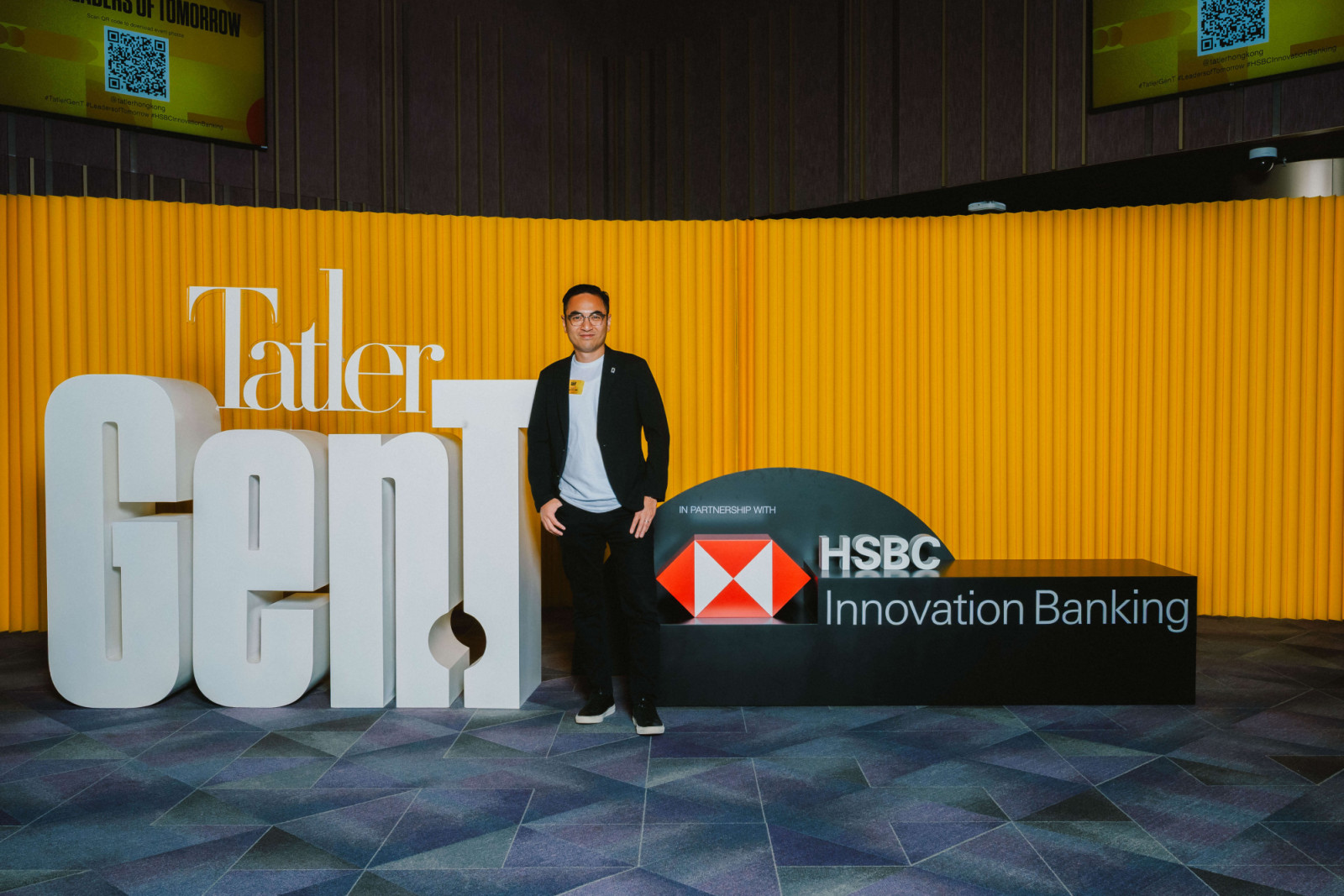 Aaron Lee, founder and CEO of Dash Living, takes a photo with the Gen.T and HSBC Innovation Banking logos (Photo: Jeffrey Hui)