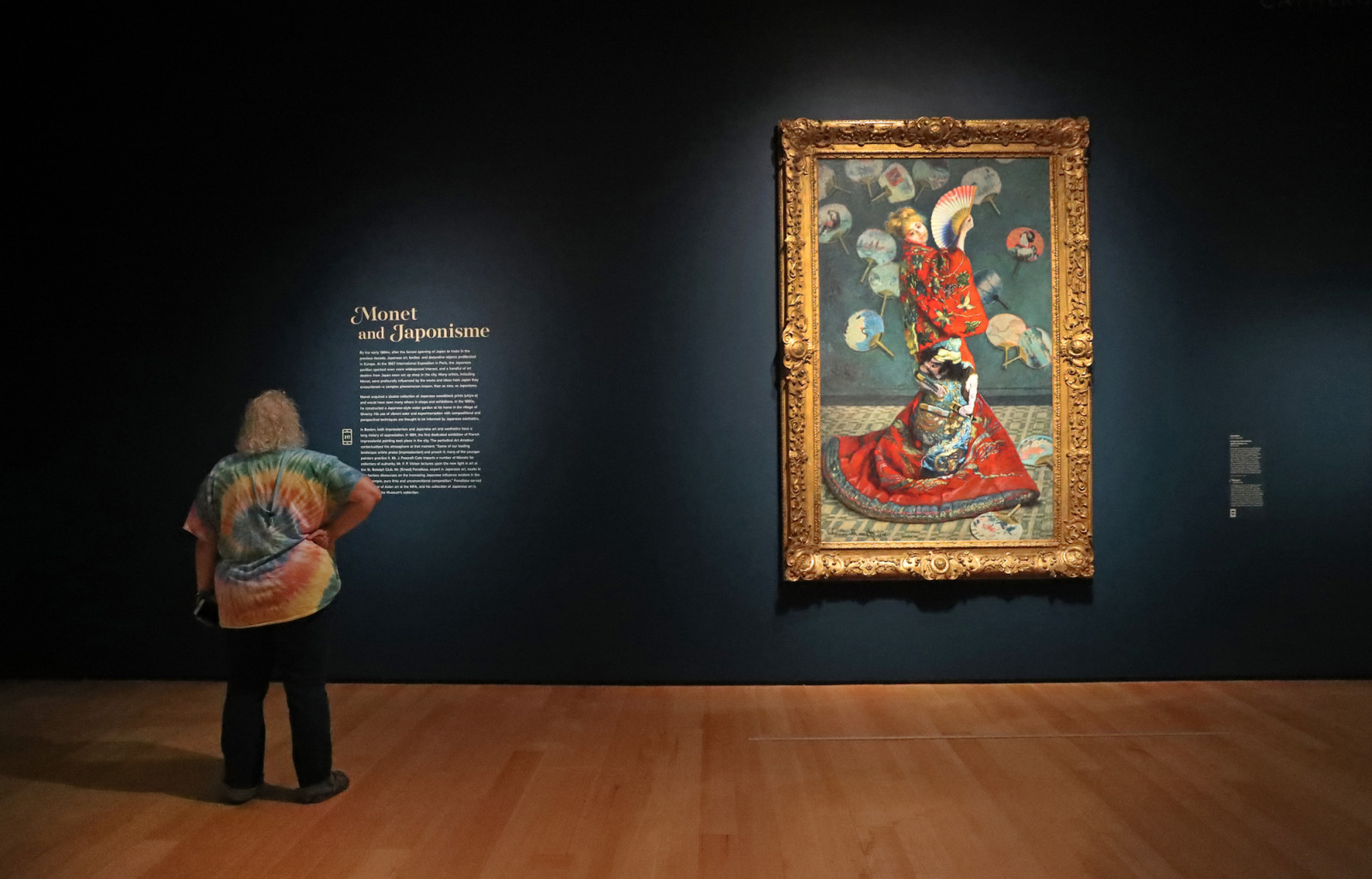 BOSTON, MA - NOVEMBER 11: A museum patron reads the text next to Monet's La Japonaise (Camille Monet in Japanese Costume),1876, at the Museum of Fine Arts Boston's Claude Monet show in Boston on Nov. 11, 2020. The show, which opened first to members only, was delayed by the COVID-19 pandemic. Monet was a French painter, a founder of French Impressionist painting. (Photo by David L. Ryan/The Boston Globe via Getty Images)