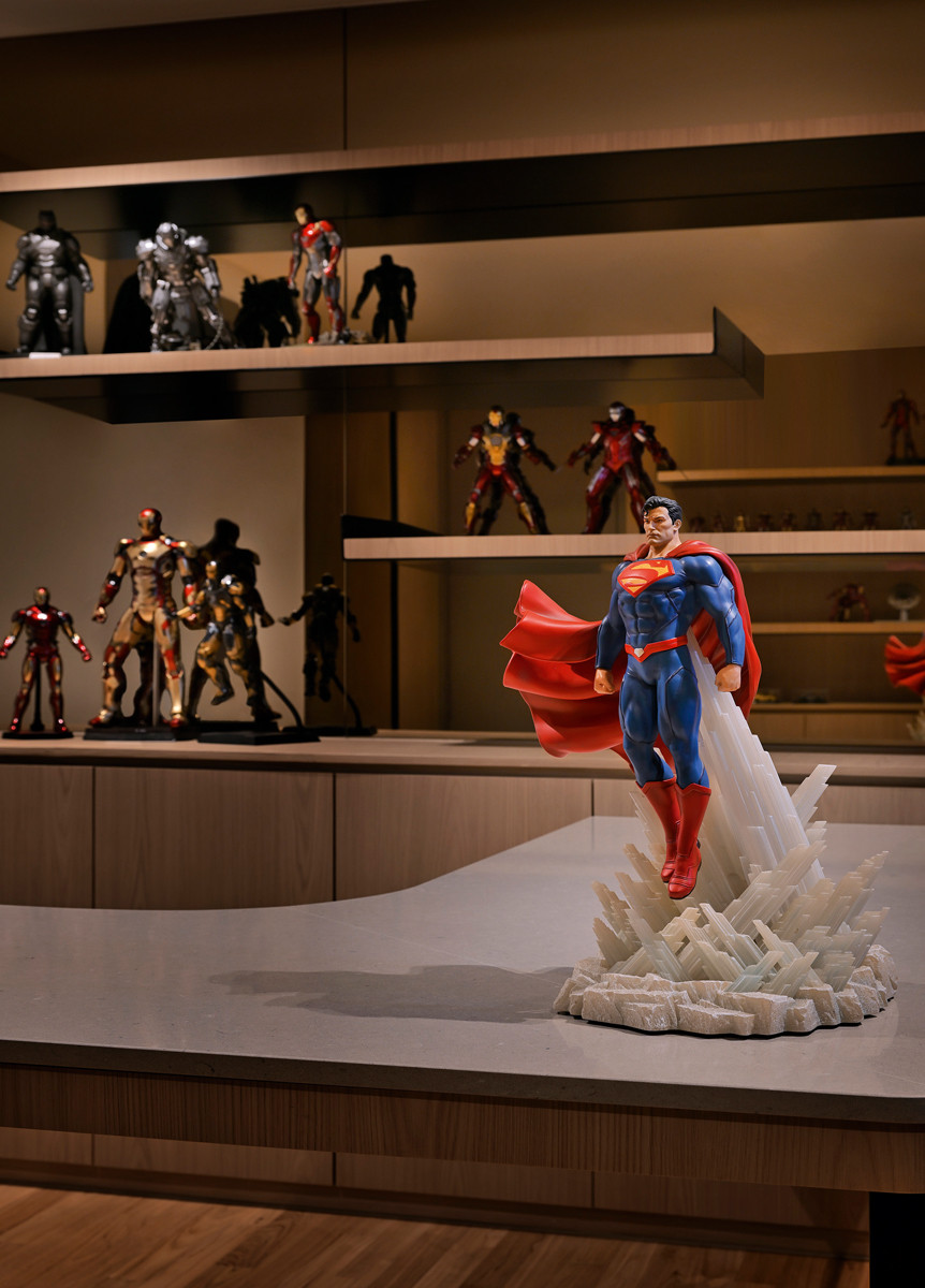 The husband’s impressive superhero figurine collection adds colour and character to the terrace house’s sleek home office
