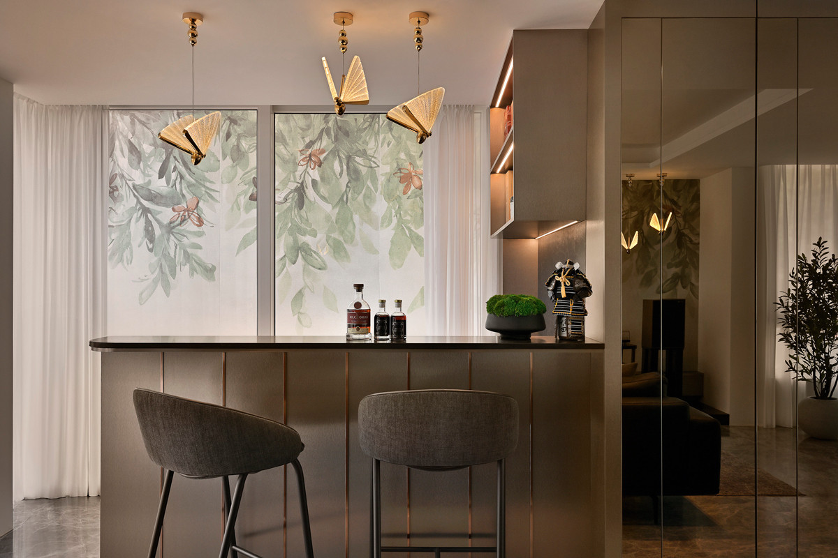 The bar area features statement tiles, complemented with butterfly-shaped pendant lights