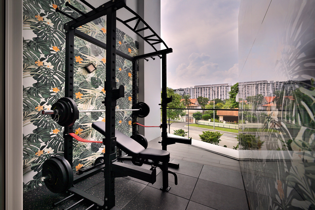The terrace house’s outdoor gym is fitted with floral-patterned Hafary tiles and a power rack