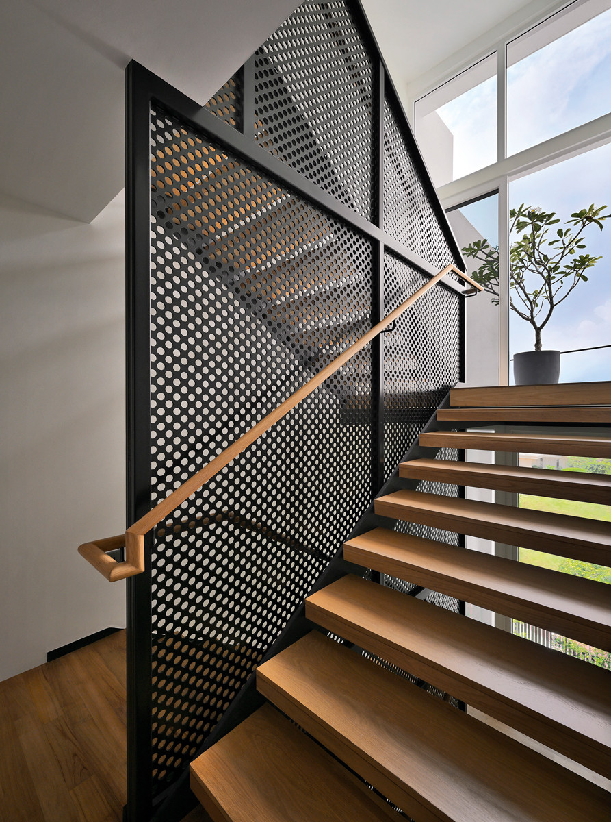 The perforated-metal balustrade ensures safety while maintaining visibility and a sense of lightness