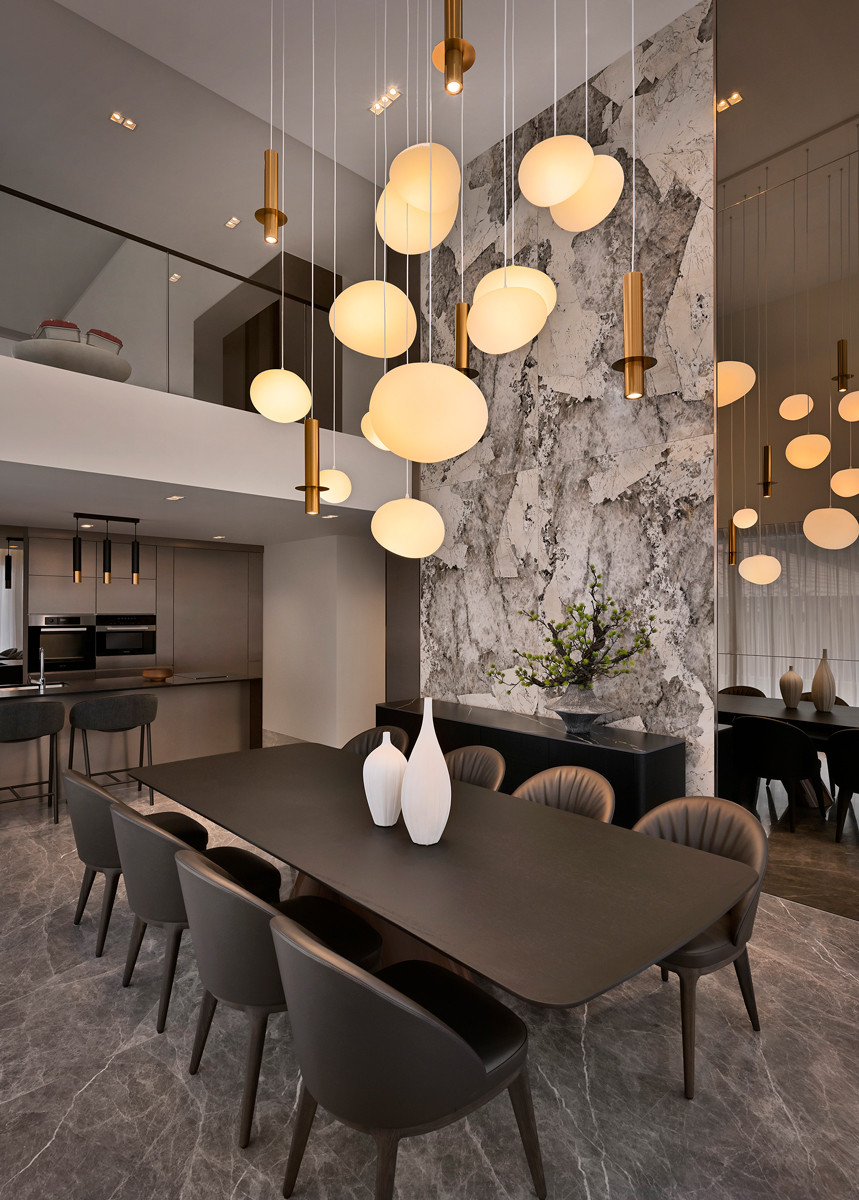 The terrace house double-height dining area feels stately and expansive while still facilitates diagonal view
