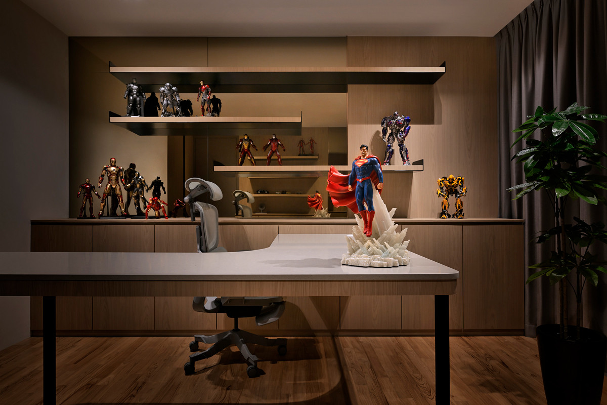 The husband’s office feels stately yet whimsical, animated by his extensive superhero figurine collection