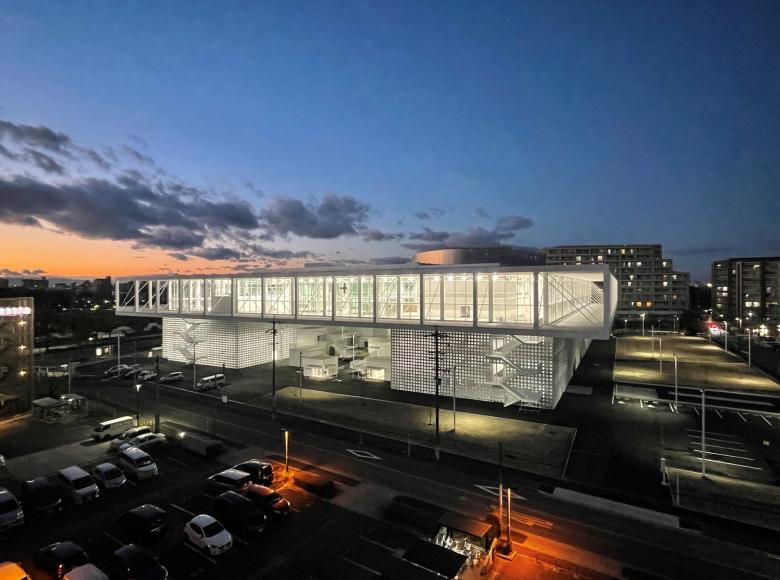 The Nagoya Zokei University's new 2022 campus, designed as a bridge over Meijo Koen Station, features an 88-by-88 metre open top floor uniting diverse art and design disciplines under one communal roof