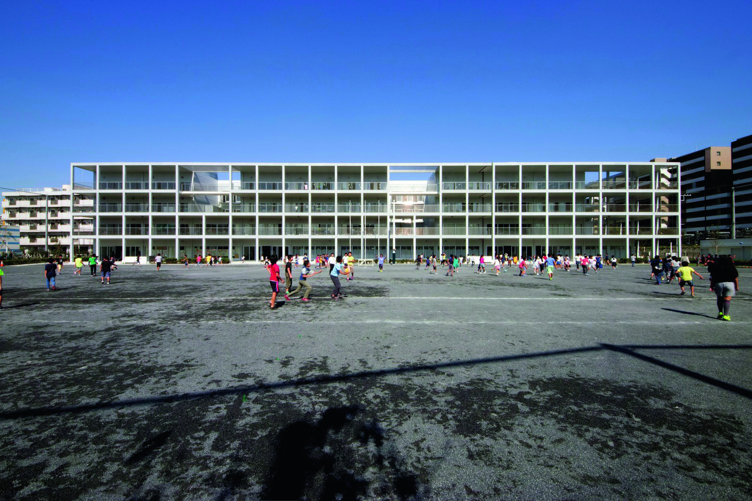 Koyasu Elementary School in Yokohama, designed by Riken Yamamoto in 2018, features open terraces that connect classrooms and foster a transparent, communal learning environmen