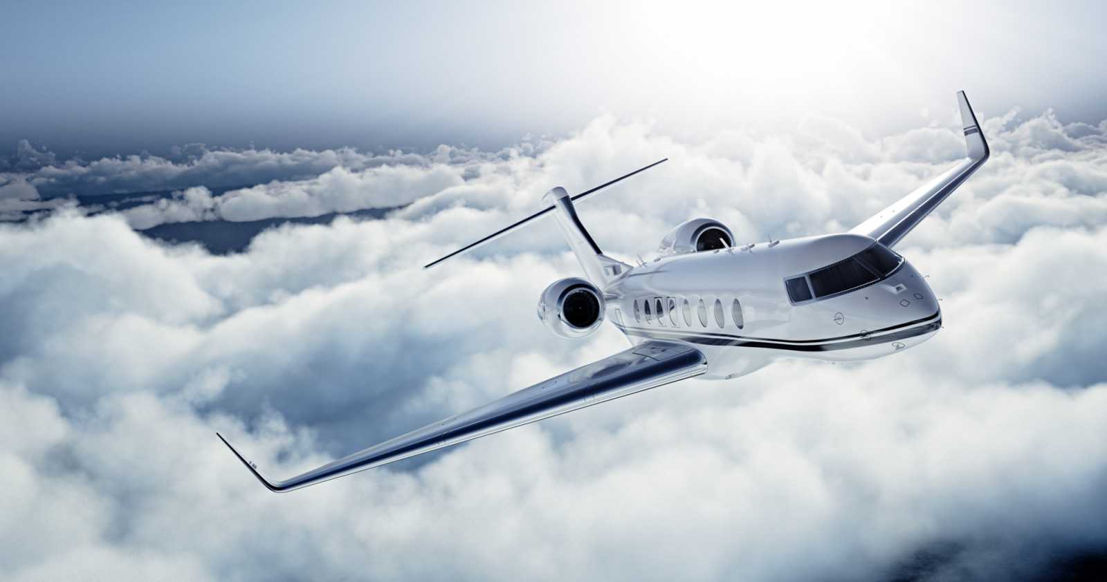 Realistic photo of White Luxury generic design private jet flying over the earth. Empty blue sky with white clouds at background. Business Travel Concept. Horizontal. (ภาพ: Pinkypills / Getty Images)