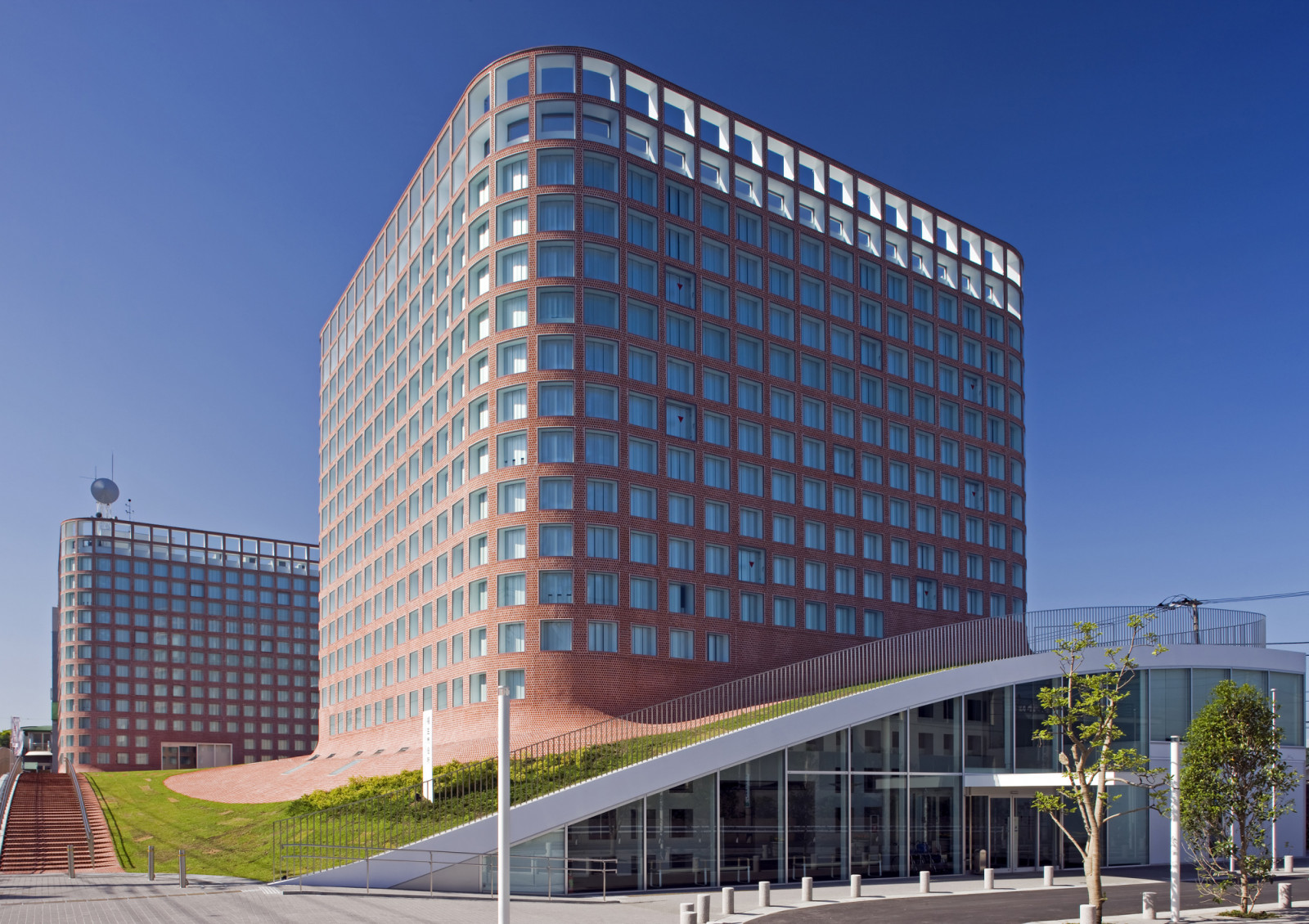 One of Fussa City Hall’s twin towers, designed by Riken Yamamoto, rises modestly above the neighbourhood, its façade clad in red brick tiles that echo the surrounding cityscape
