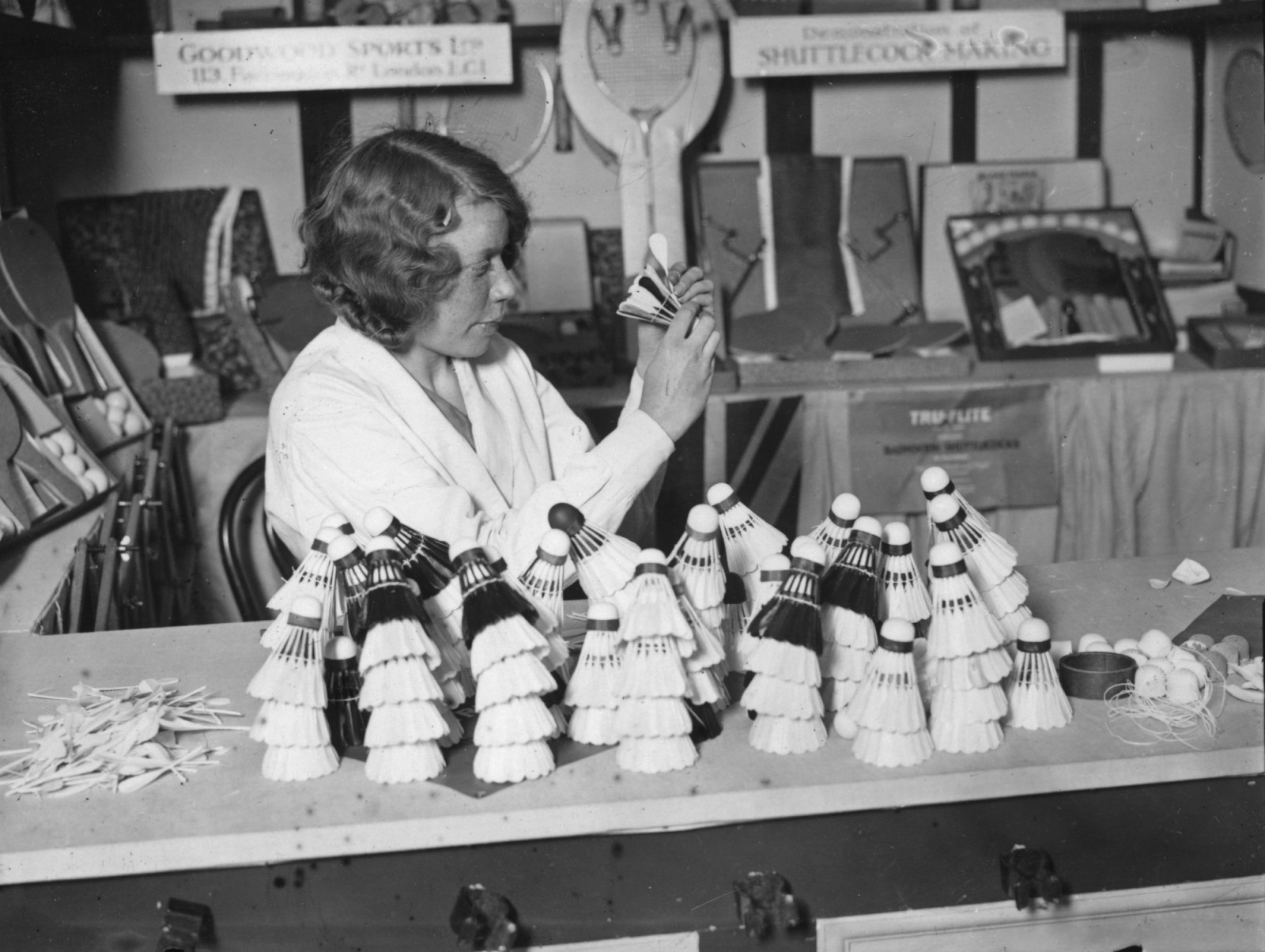 25th February 1932: A girl making shuttlecocks at the British Industries Fair at Olympia, London. (Photo by A. Hudson/Topical Press Agency/Getty Images)