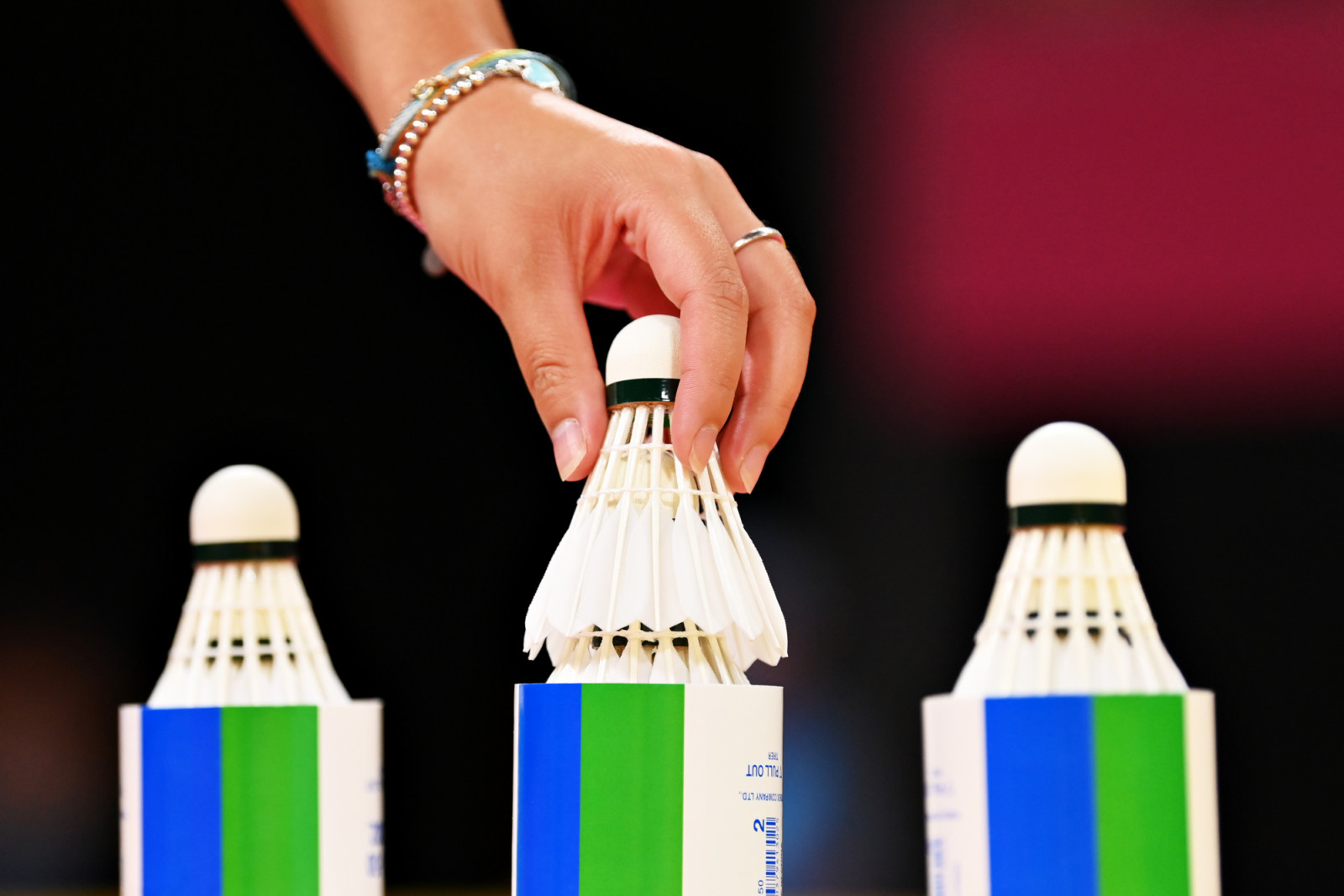 BIRMINGHAM, ENGLAND - AUGUST 05: A detail shot as Jessica Li of Team Isle of Man picks up a shuttlecock during their Badminton Women's Singles Round of 16 match against Kirsty Gilmour of Team Scotland on day eight of the Birmingham 2022 Commonwealth Games at NEC Arena on August 05, 2022 on the Birmingham, England. (Photo by Justin Setterfield/Getty Images)