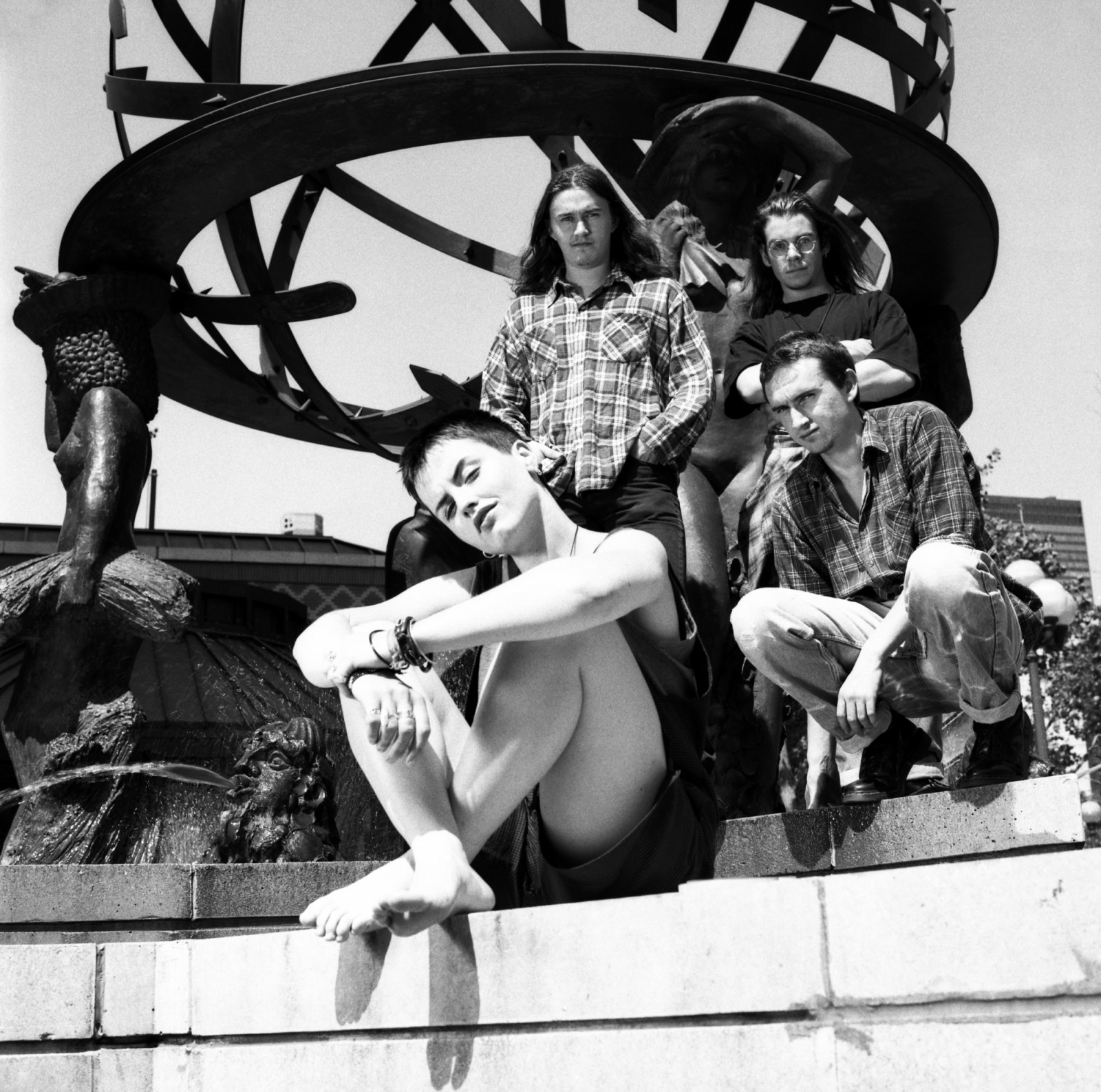 NEW YORK, NY - JUNE, 1995: (L-R) Lead singer Dolores O'Riordan (1971-2018), guitarist Noel Hogan, bassist Michael Hogan and drummer Fergal Lawler of the Irish rock band The Cranberries pose for a group portrait in front of a city sculpture circa June, 1995 in New York City, New York. (Photo by Bob Berg/Getty Images)
