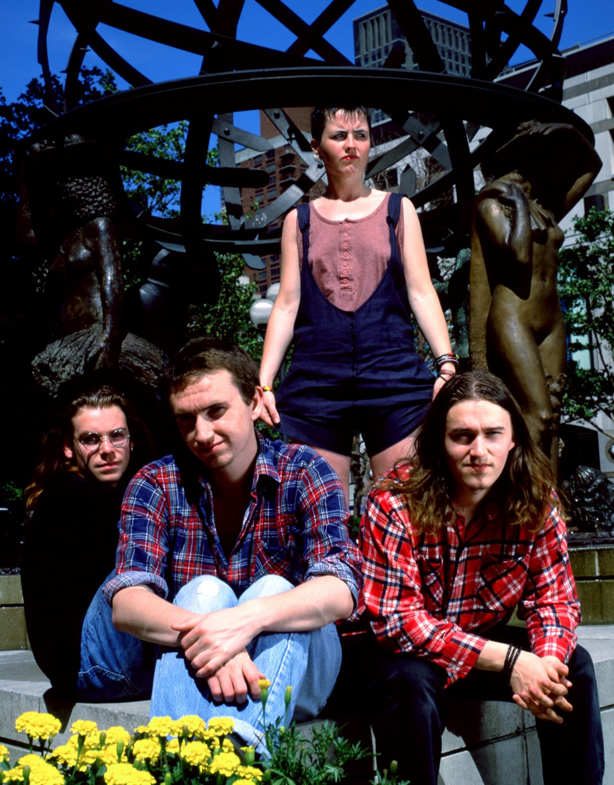 NEW YORK, NY - JUNE, 1995: (L-R) Bassist Michael Hogan, drummer Fergal Lawler, lead singer Dolores O'Riordan (1971-2018) and guitarist Noel Hogan of the Irish rock band The Cranberries pose for a group portrait in front of a city sculpture circa June, 1995 in New York City, New York. (Photo by Bob Berg/Getty Images)