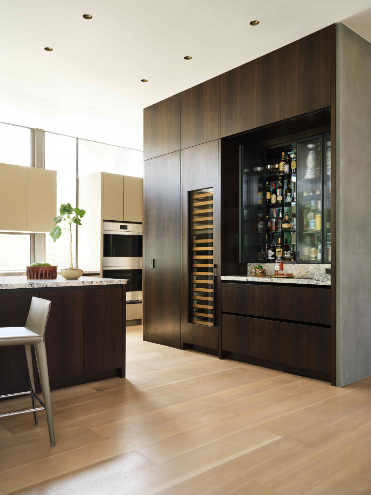 A dark oak cabinetry in the kitchen anchors the space
