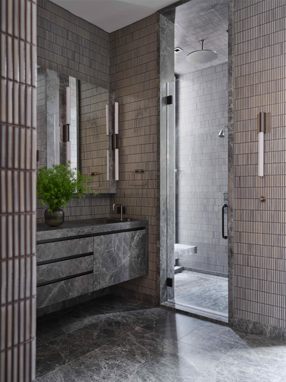 Dark blue Japanese tiles and dark Icelandic marble in the primary suite