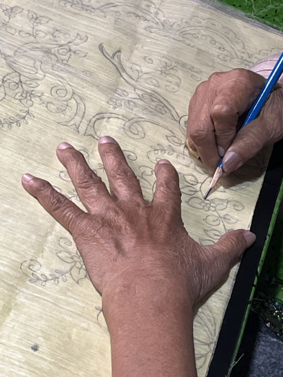 A local artisan in action, transferring a design to a textile (Photo: courtesy of the Carrot Brand)