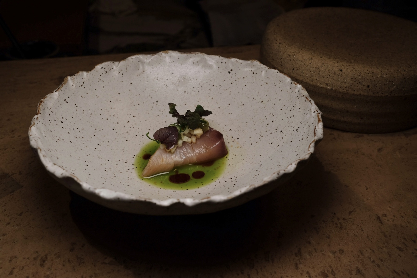 Chipta 11a's amberjack sashimi, topped with finely sliced jicama, and topped with garlic chive oil, aged soy, spring onions and pickled wasabi