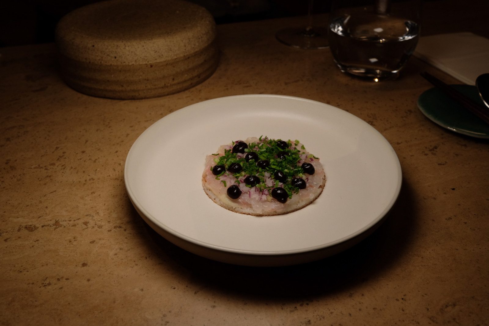 Chipta 11a's sea bream tartare on a thosai dressed with chives, shallots, budu garum and strawberry vinegar gel