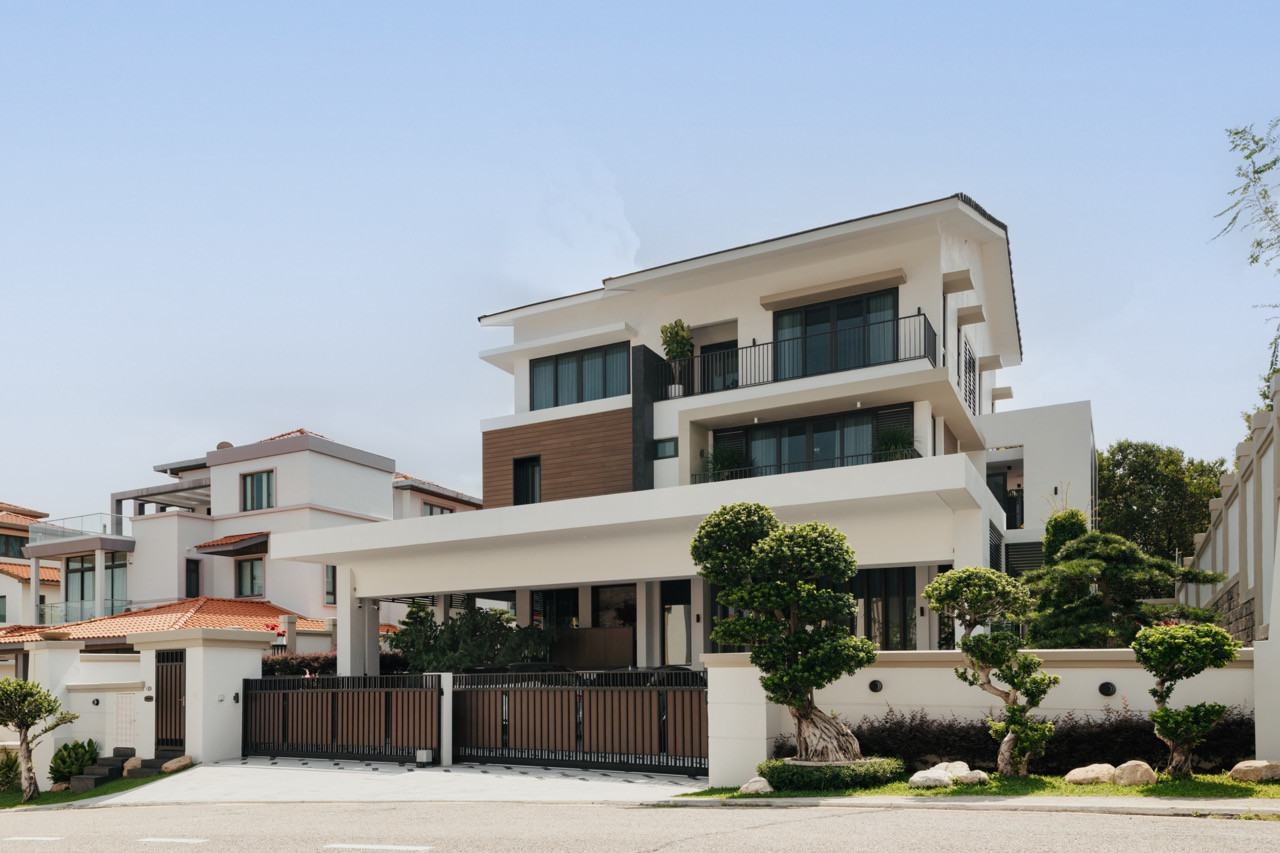 The renovated three-story facade in Batu Uban showcases contemporary lines with timber accents and generous windows that flood the interior with natural light