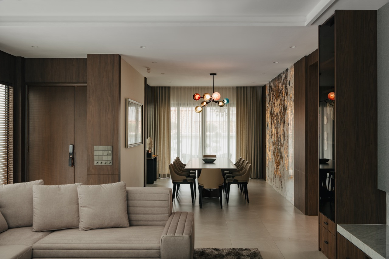The open-plan living and dining area features darker timber tones on the ground floor to create a grand and elegant atmosphere