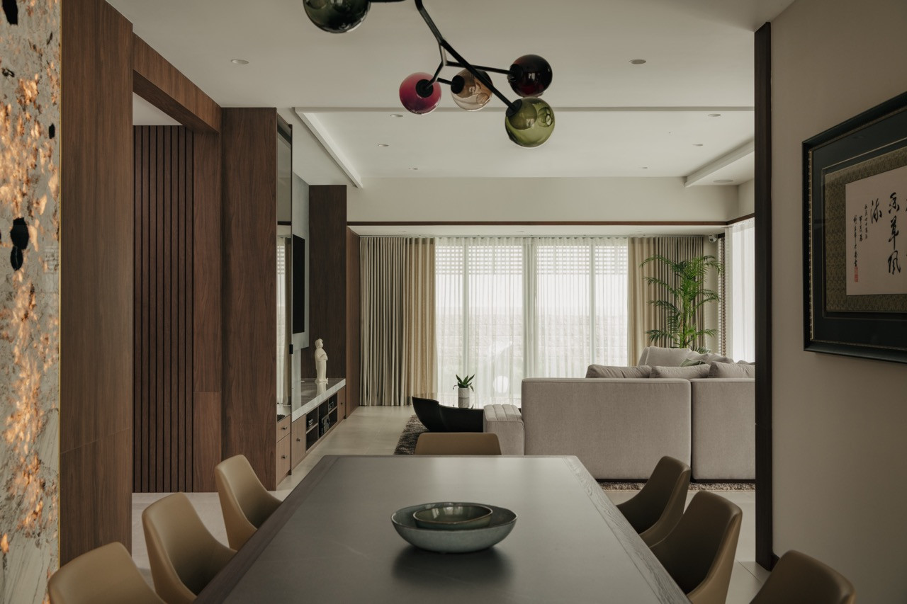 The dining area in this Penang house renovation displays Velis dining chairs by Mario Ferrarini for Potocco beneath the Bocci 28.9 Armature pendant light by Omer Arbel