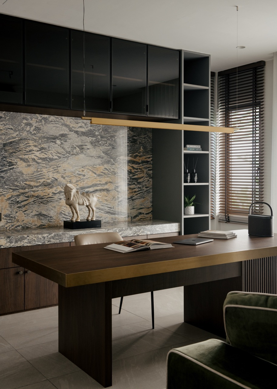 The home office features Mountain Wave marble as a feature wall behind the desk, while dark cabinetry offers organised storage for work-from-home needs.