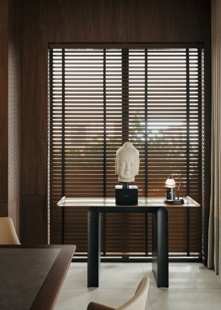 A corner vignette displays a Buddha sculpture from the owner's collection alongside contemporary furnishings