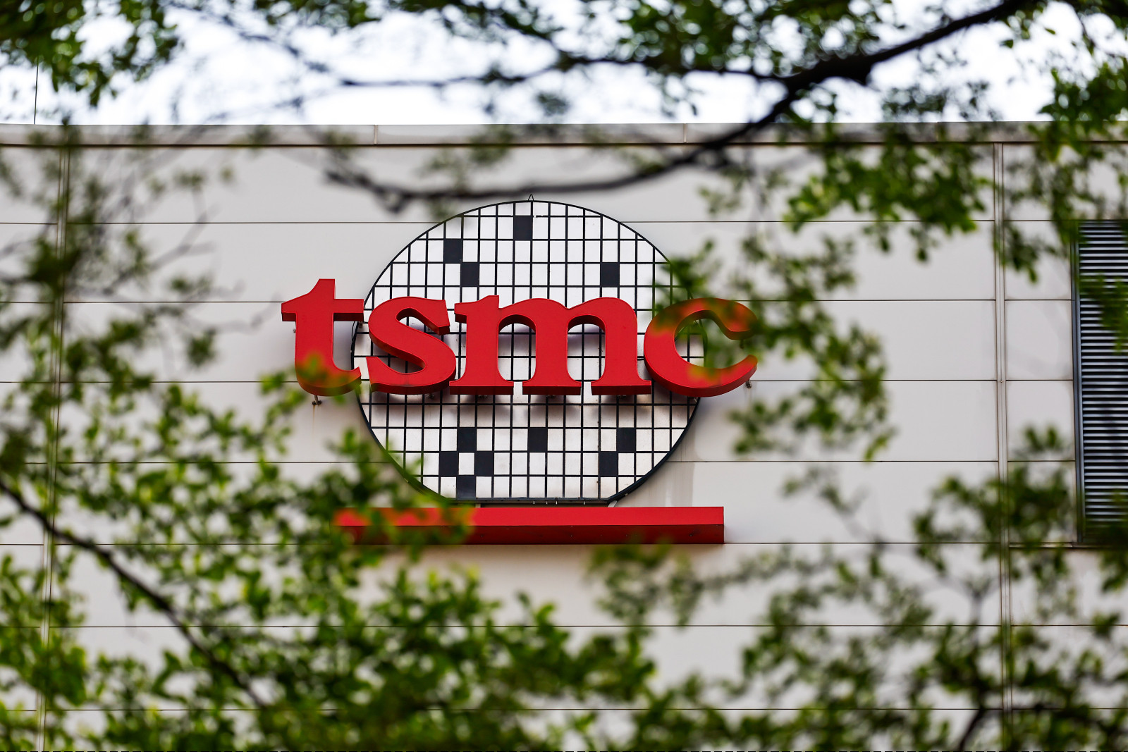 HSINCHU, TAIWAN - APRIL 16: The logo of Taiwan Semiconductor Manufacturing Company (TSMC), which is a Taiwanese multinational semiconductor contract manufacturing and design company, in Hsinchu, Taiwan, on April 16, 2025. The United States President Donald Trump's administration has confirmed that tariffs on semiconductors and some other technology products will 'take place in the very near future'. With tariffs and export restrictions expected to be implemented by the American government, electronic produc