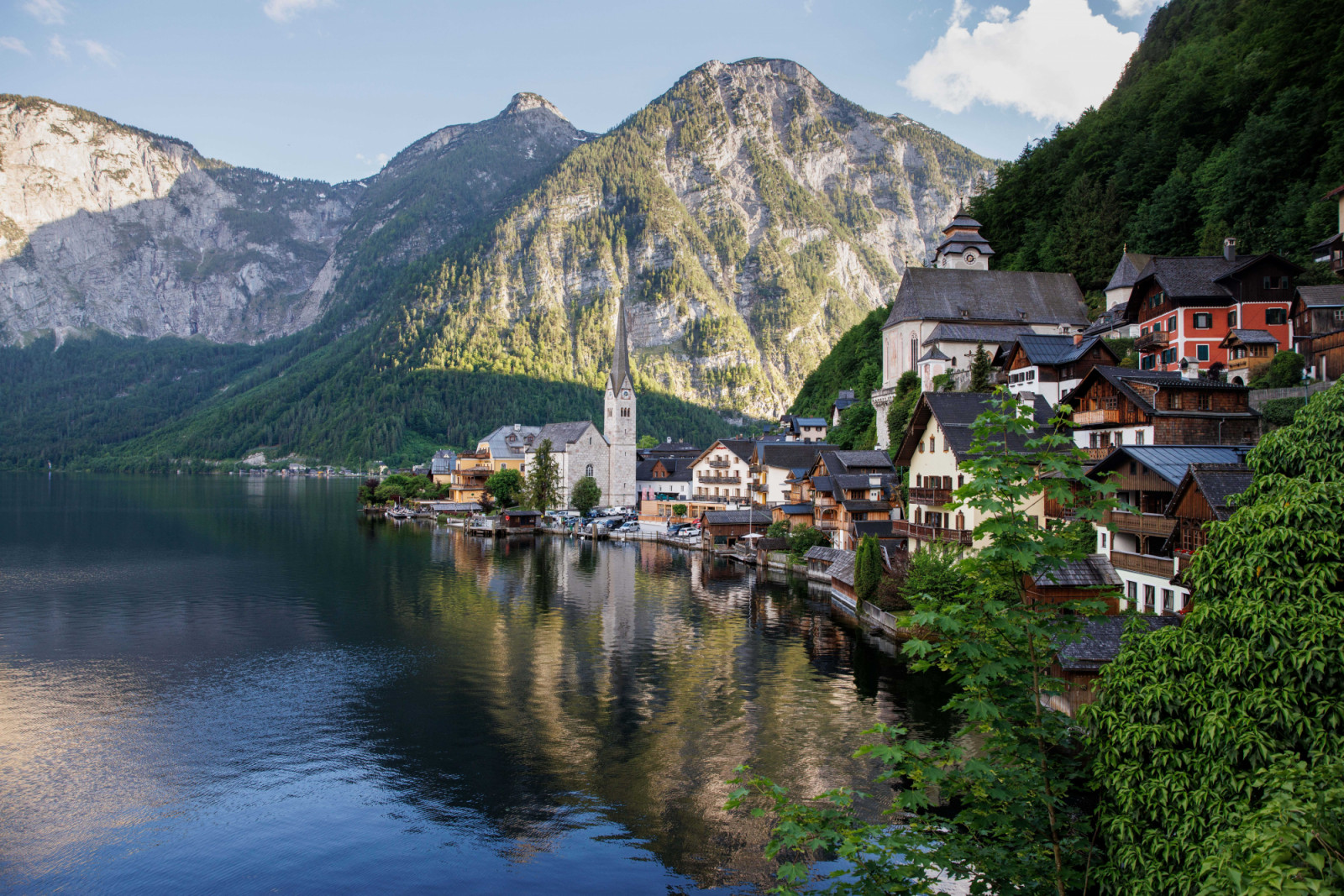 18 May 2024, Austria, Hallstatt: The Catholic parish church of Hallstatt and the Protestant parish church of Hallstatt can be seen on 18.05.2024 in Hallstatt in Upper Austria (Austria) in front of the Alpine panorama over Lake Hallstatt. The viewpoint on Lake Hallstatt has become a real "insta-hotspot", attracting countless tourists every day. Photo: Matthias Balk/dpa (Photo by Matthias Balk/picture alliance via Getty Images)