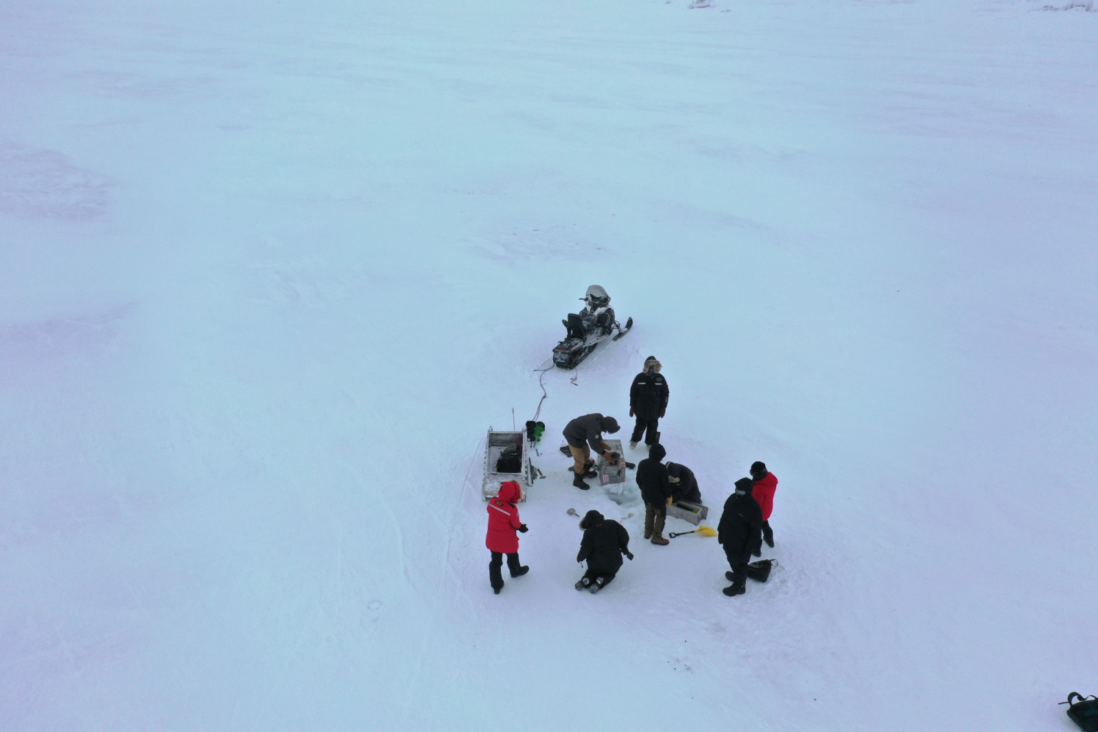 Aerial view of the science team collecting ice water samples.
©Kaitlyn Van De Woestyne/National Geographic