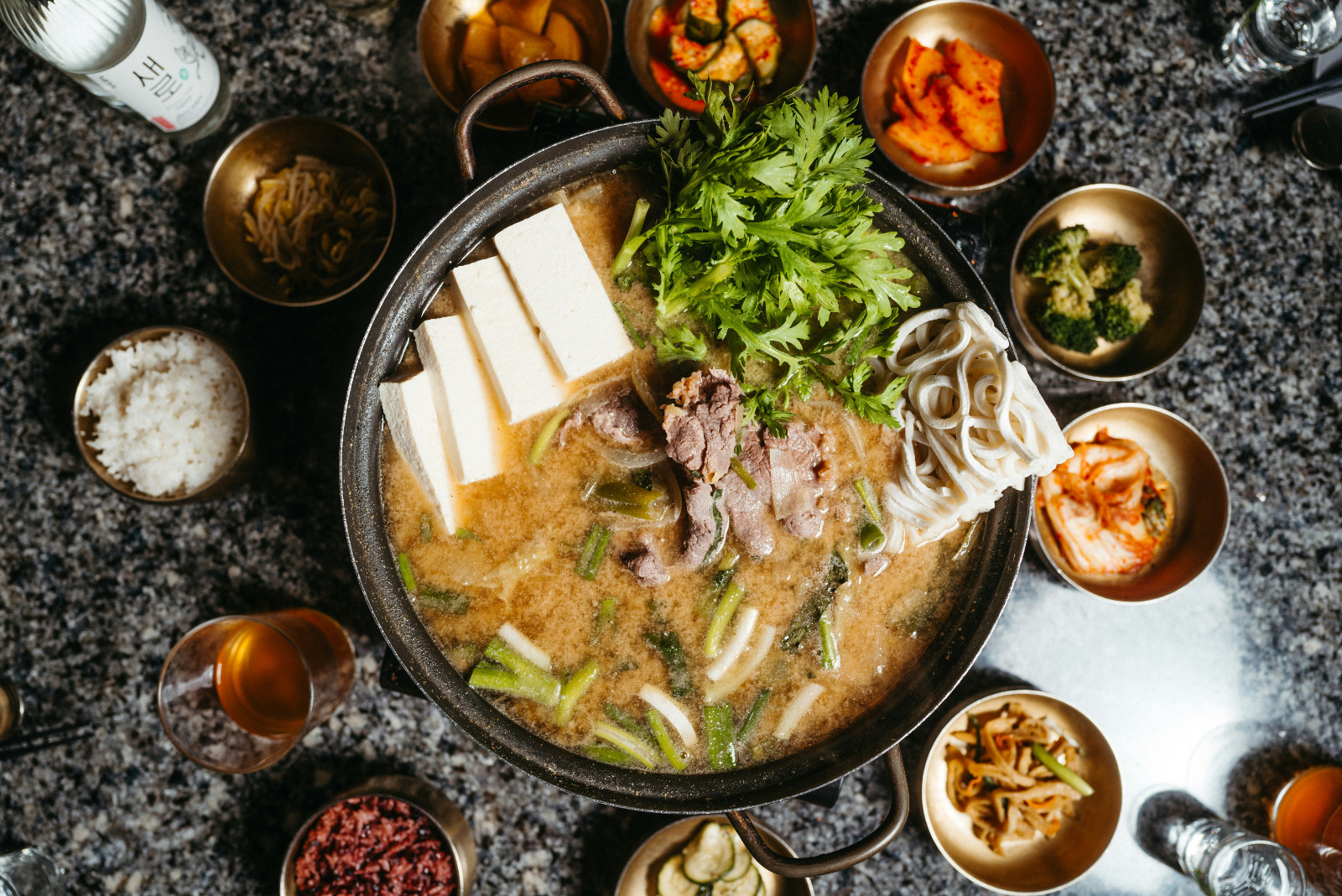 Korean broth with side dishes.