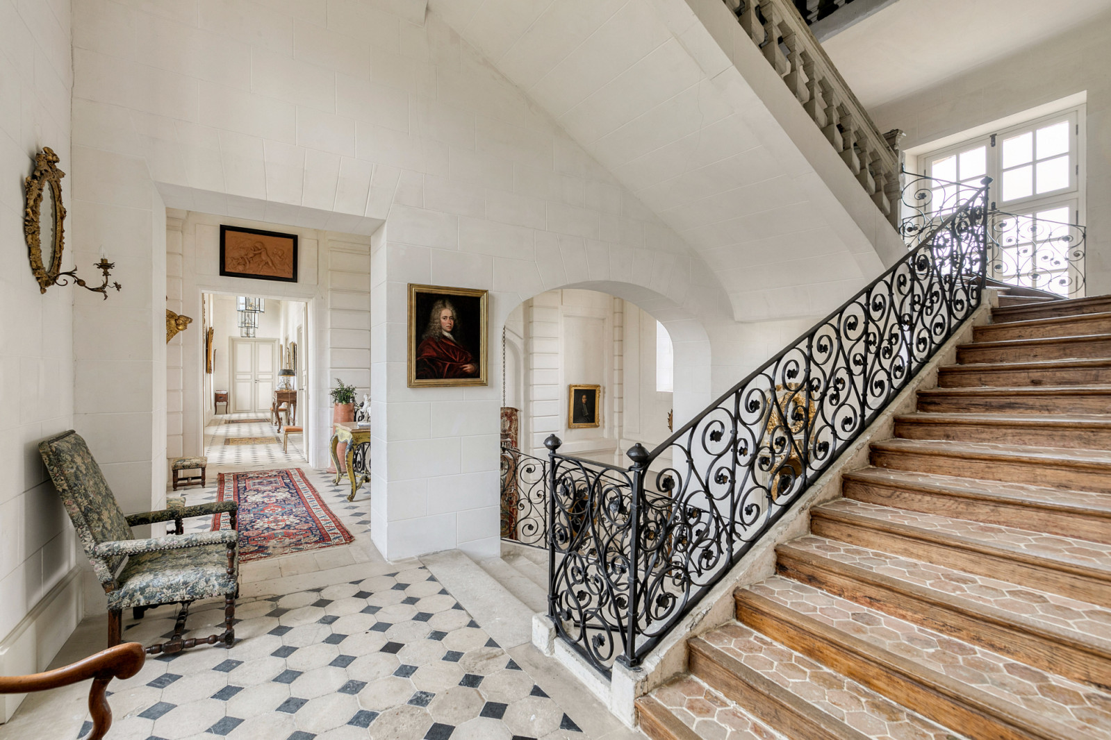 The château’s entrance hall displays period stone work and architectural elements from the building, constructed as a contemporary of Louis XIII's hunting lodge at Versailles