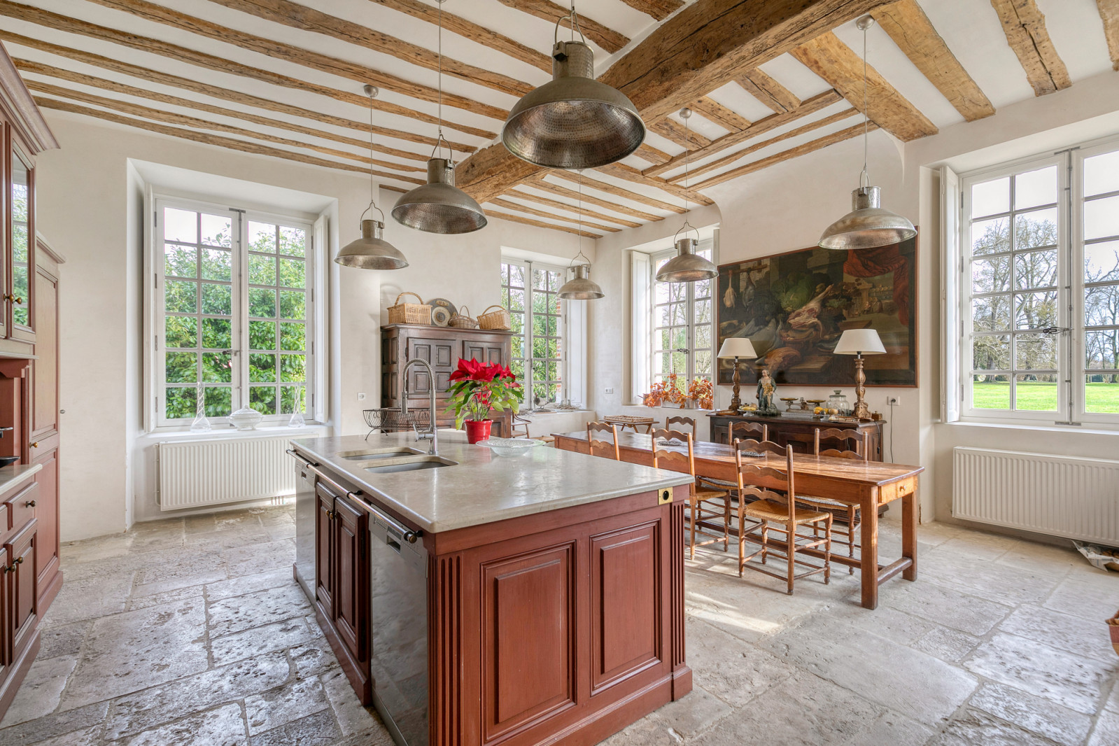 The château’s kitchen combines modern functionality with original architectural features, part of the 18,299 square foot historic property in Normandy's Eure Valley