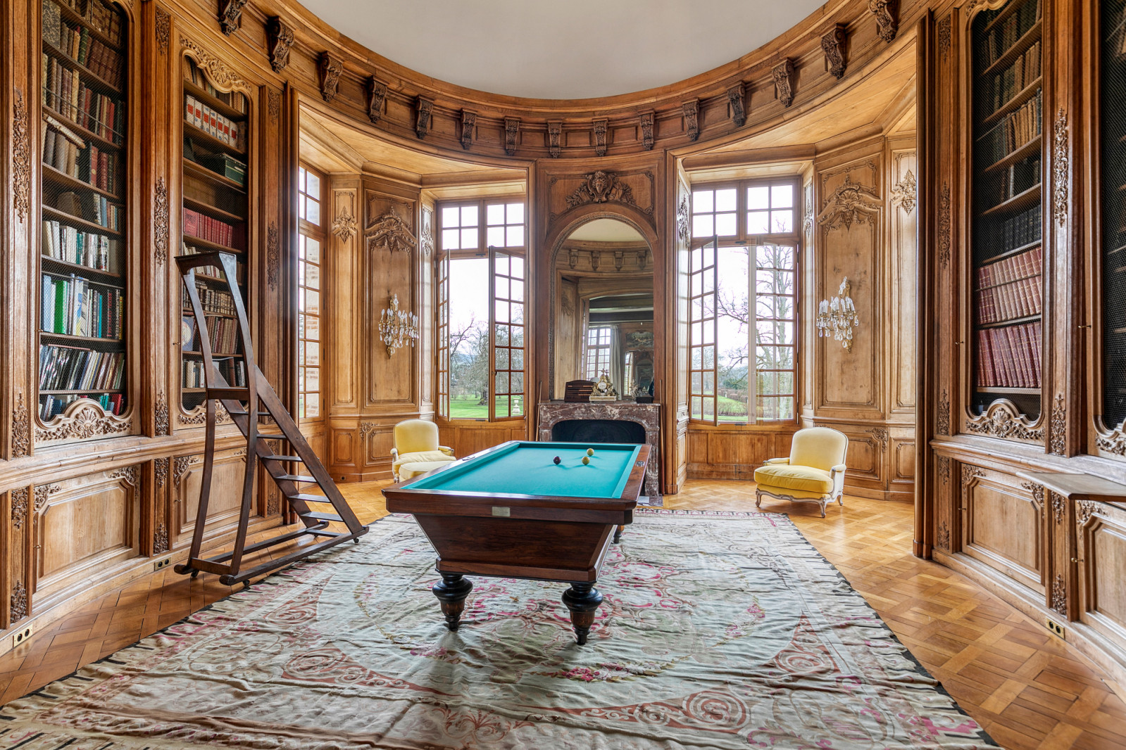 Library space within the château showing the integration of period architecture with functional living areas, part of the comprehensive restoration completed under government supervision