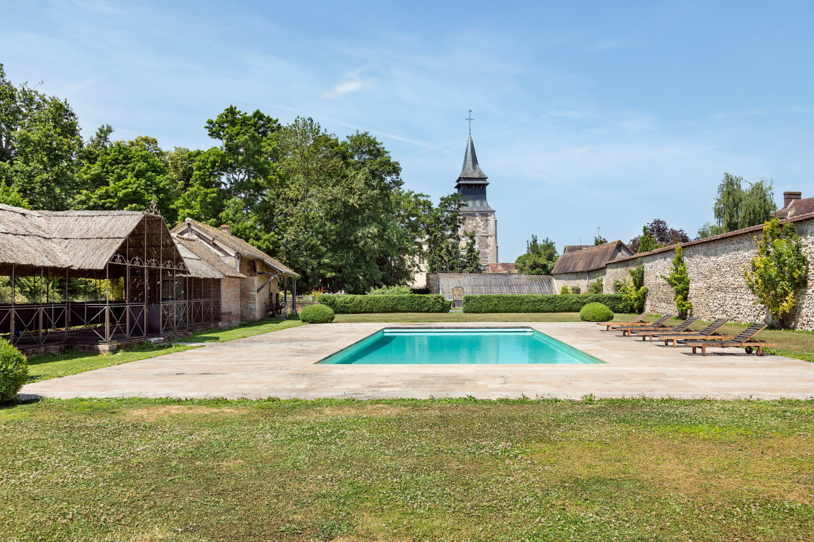 Estate grounds include modern amenities like the swimming pool, while maintaining the property's historic character and connection to the romantic lake and orchard areas