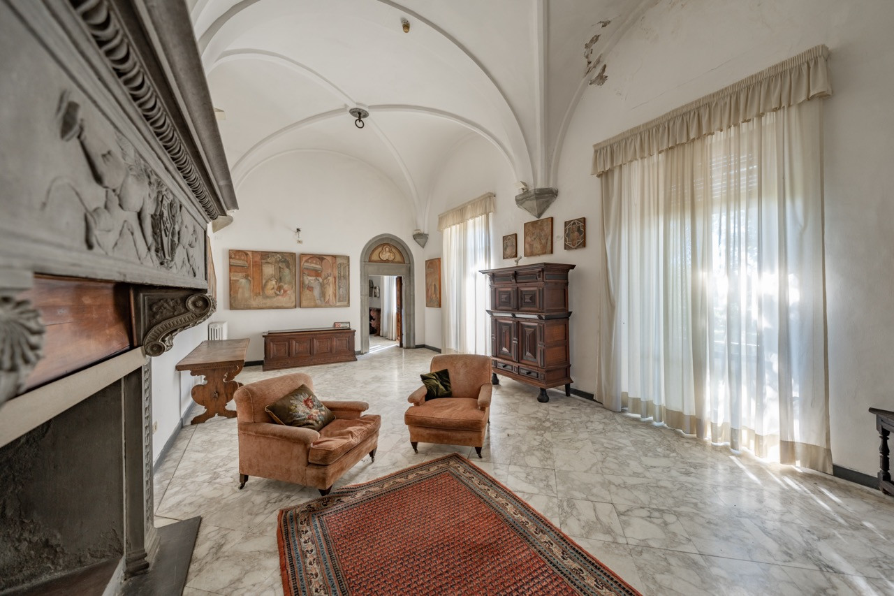 One of five vaulted reception halls surrounding the central courtyard at Castello di Vincigliata, showcasing the medieval architecture of this historic European castle for sale near Florence