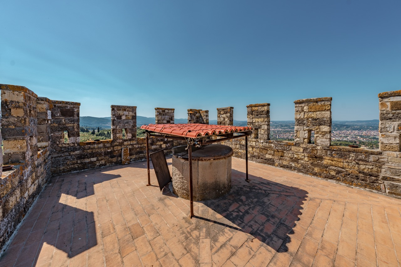 Crenellated tower terrace at Castello di Vincigliata offering commanding views over the surrounding Tuscan countryside, accessible via the chemin de ronde running around the castle perimeter