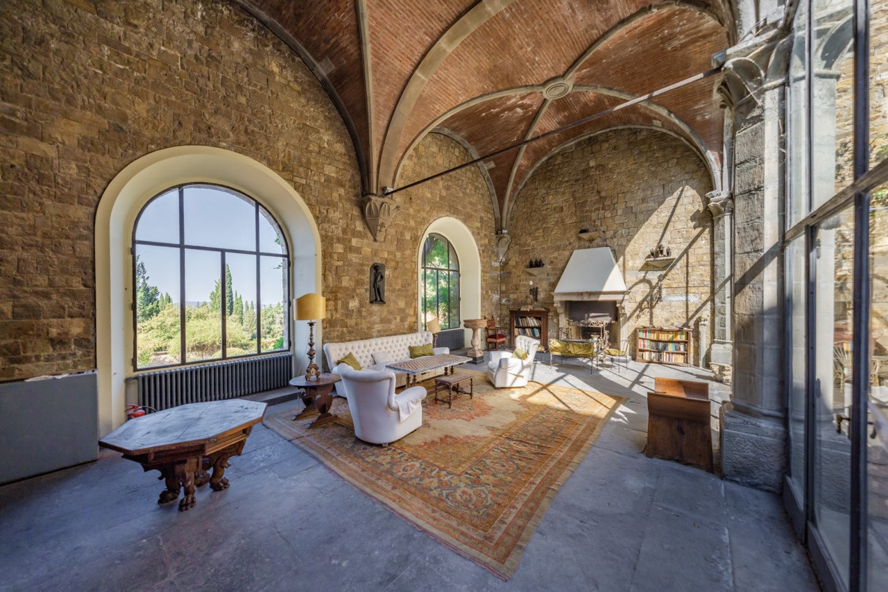 Reception area with panoramic windows at Castello di Vincigliata offering views over the Tuscan landscape, typical of the breathtaking vistas from this historic European castle's upper terraces
