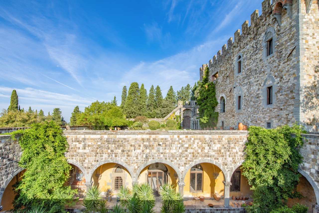Panoramic view of Castello di Vincigliata’s castle and estate buildings showing the stone arches and terraced gardens that characterise this historic European castle’s architectural evolution over nearly a millennium
