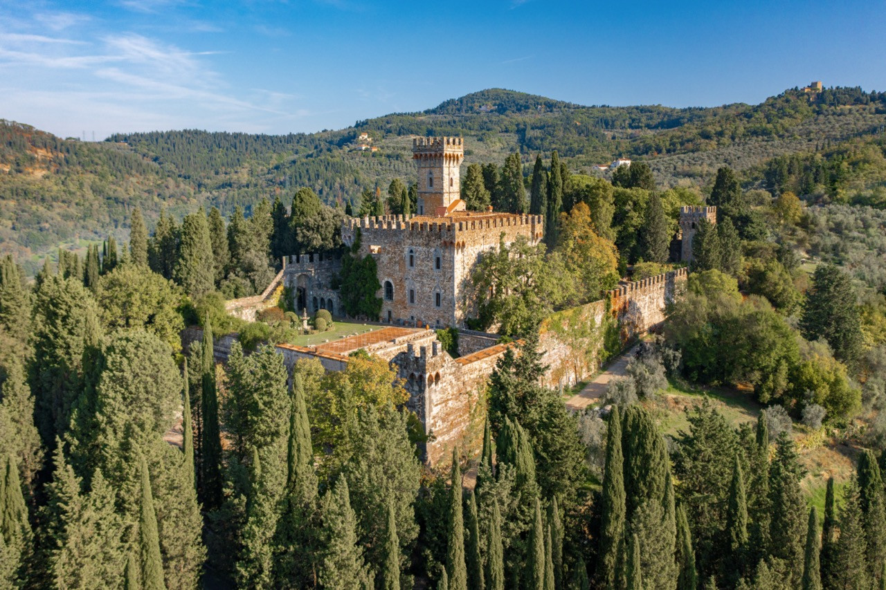 Golden hour view of Castello di Vincigliata, highlighting the neo-Gothic restoration completed by architect Giuseppe Fancelli under John Temple Leader’s direction, showcasing this historic European castle's transformation from medieval ruins to an architectural masterpiece